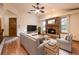 Inviting living room featuring a brick fireplace and comfortable seating area at 1130 Woodchuck Ct, Orange City, FL 32763