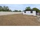 Large backyard featuring a white fence, and a white house with dark trim at 114 Spring Lake Cir, Ocoee, FL 34761