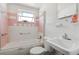 Vintage bathroom featuring pink and white tile, with a shower-tub combo and classic fixtures at 114 Spring Lake Cir, Ocoee, FL 34761