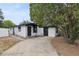 Charming single-story home featuring the front exterior with a concrete driveway and black accents at 114 Spring Lake Cir, Ocoee, FL 34761