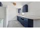The kitchen features a white refrigerator, blue cabinets, and a view to the outside at 114 Spring Lake Cir, Ocoee, FL 34761