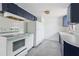 A kitchen features vintage appliances, blue cabinets, white countertops, and white tiled backsplash at 114 Spring Lake Cir, Ocoee, FL 34761