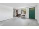 The living room is bright, with gray floors, neutral walls, and a green entry door at 114 Spring Lake Cir, Ocoee, FL 34761