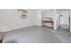 An empty living room featuring gray flooring, an air conditioner and a window with natural light at 114 Spring Lake Cir, Ocoee, FL 34761
