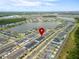 Expansive aerial view of the community, showcasing its layout by a picturesque lake at 11607 Sunsail Ave, Orlando, FL 32832