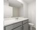Cozy bathroom with white countertops, grey cabinets, and tiled shower, offering a practical and clean space at 11607 Sunsail Ave, Orlando, FL 32832