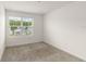 Clean bedroom with plush carpet and bright window, offering serene retreat from the day at 11607 Sunsail Ave, Orlando, FL 32832