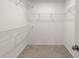 Spacious walk-in closet with wire shelving that maximizes storage space in a carpeted area at 11607 Sunsail Ave, Orlando, FL 32832