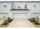 Inviting front facade featuring a three-car garage, well-maintained landscaping and modern architecture at 11607 Sunsail Ave, Orlando, FL 32832