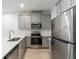 Modern kitchen with gray cabinets, stainless steel appliances, and a center island with a sink at 11607 Sunsail Ave, Orlando, FL 32832