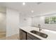 Kitchen featuring an island with sink, modern appliances, and a view into the living area at 11607 Sunsail Ave, Orlando, FL 32832
