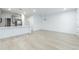 Bright living room with hardwood floors adjacent to the kitchen with gray cabinets and stainless steel appliances at 11607 Sunsail Ave, Orlando, FL 32832
