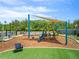 A colorful community playground with a slide, swings, and comfortable seating amid well-maintained surroundings at 11607 Sunsail Ave, Orlando, FL 32832