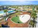 A vibrant community playground featuring a splash pad, swings, and various recreational elements under the sunny sky at 11607 Sunsail Ave, Orlando, FL 32832