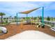 A well-equipped community playground with climbing structures, seating, and shade creating an inviting play space at 11607 Sunsail Ave, Orlando, FL 32832