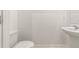 Clean powder room featuring a pedestal sink and modern toilet, conveniently located near the main living areas at 11607 Sunsail Ave, Orlando, FL 32832