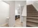 Carpeted staircase leading to the upper level, adjacent to the open-concept kitchen and living area at 11607 Sunsail Ave, Orlando, FL 32832
