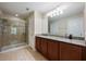 Elegant bathroom with a double vanity, granite countertop, a glass-enclosed shower, and tiled floors at 11908 Fiore Dr # 1, Orlando, FL 32827