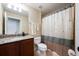 Cozy bathroom featuring a shower with curtain, granite countertop vanity, and tiled floors at 11908 Fiore Dr # 1, Orlando, FL 32827