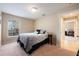 A cozy bedroom featuring a window for natural light and neutral-toned walls at 11908 Fiore Dr # 1, Orlando, FL 32827