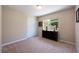 Comfortable bedroom with plush carpet, a bright window overlooking the yard, and neutral paint for versatility at 11908 Fiore Dr # 1, Orlando, FL 32827