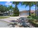 Charming single-story home featuring a brick driveway, two-car garage, and well-manicured landscaping with mature trees at 11908 Fiore Dr # 1, Orlando, FL 32827