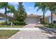 Charming home exterior featuring a paver driveway, two-car garage, and well-manicured landscaping at 11908 Fiore Dr # 1, Orlando, FL 32827