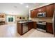 Modern kitchen featuring stainless steel appliances, granite countertops, and a seamless transition into the dining area at 11908 Fiore Dr # 1, Orlando, FL 32827