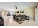 Inviting living room with tile floors, comfortable seating, and view into the dining room with lots of natural light at 11908 Fiore Dr # 1, Orlando, FL 32827