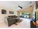 Cozy living room featuring sliding glass doors to a patio, comfortable seating, and tile flooring for easy maintenance at 11908 Fiore Dr # 1, Orlando, FL 32827