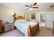 Relaxing main bedroom featuring a four-poster bed, ceiling fan, and ensuite bathroom for added privacy at 11908 Fiore Dr # 1, Orlando, FL 32827