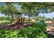 Fun-filled community playground with a slide, climbing structures, and soft turf for safety at 11908 Fiore Dr # 1, Orlando, FL 32827