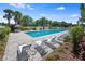 Refreshing community pool with lounge chairs, palm trees, and a clear blue swimming area at 11908 Fiore Dr # 1, Orlando, FL 32827
