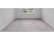 Empty bedroom featuring plush carpeting and a window with a neighborhood view at 1339 Wood Line Dr, Deland, FL 32720