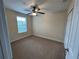 Bright bedroom with a ceiling fan, large window, closet and neutral paint at 135 Heritage Park St, Winter Springs, FL 32708