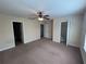 Spacious bedroom with two closets, ceiling fan, and two entrances at 135 Heritage Park St, Winter Springs, FL 32708