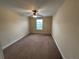 Neutral bedroom featuring carpet flooring, a ceiling fan, and a window for natural light at 135 Heritage Park St, Winter Springs, FL 32708