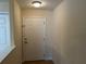 Bright and airy foyer with a classic white door, showcasing neutral walls and tile flooring at 135 Heritage Park St, Winter Springs, FL 32708