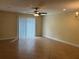 Spacious living room with tile floors, bathed in natural light, with ceiling fan and sliding glass door at 135 Heritage Park St, Winter Springs, FL 32708