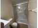 Bathroom featuring a glass-door shower, neutral tile, and modern fixtures at 135 Heritage Park St, Winter Springs, FL 32708