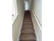Carpeted staircase with white railings, providing a seamless transition between floors at 135 Heritage Park St, Winter Springs, FL 32708