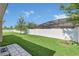Spacious backyard features lush green grass, white fence, and mature landscaping for outdoor enjoyment at 1545 Caterpillar St, St Cloud, FL 34771