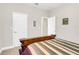 A bedroom featuring an ornate wooden bed, neutral walls, and white doors, creating a relaxing retreat at 1545 Caterpillar St, St Cloud, FL 34771