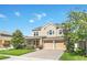 Charming two-story home with a two-car garage and colorful landscaping, creating an inviting curb appeal at 1545 Caterpillar St, St Cloud, FL 34771