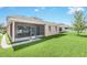 Back exterior view of home with a screened-in lanai and fenced backyard, perfect for outdoor living at 1545 Caterpillar St, St Cloud, FL 34771