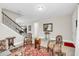 Home foyer featuring neutral walls, tile flooring, staircase, and decorative seating area at 1545 Caterpillar St, St Cloud, FL 34771