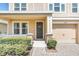 Close-up of a home entrance featuring manicured bushes, stone pillar accents, and a gray front door at 1545 Caterpillar St, St Cloud, FL 34771