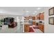 Open-concept kitchen featuring stainless steel appliances, granite countertops, and a breakfast bar overlooking the adjacent living area at 1545 Caterpillar St, St Cloud, FL 34771
