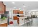 Well-appointed kitchen boasts stainless steel appliances, granite counters, tile floor, and island seating at 1545 Caterpillar St, St Cloud, FL 34771