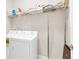 Bright laundry room featuring modern washer and dryer and practical wire shelving for organized storage at 1545 Caterpillar St, St Cloud, FL 34771